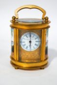 A French miniature brass and porcelain carriage clock, hand painted with courting couples,