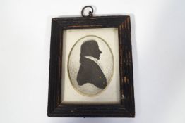 An early 19th century portrait silhouette of a Gentleman, watercolour and gilt highlights, framed,