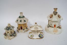 Four 19th century and later Staffordshire pastille burner cottages,