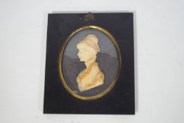 An early 19th century style wax profile bust of a young lady in rectangular simulated papier mache
