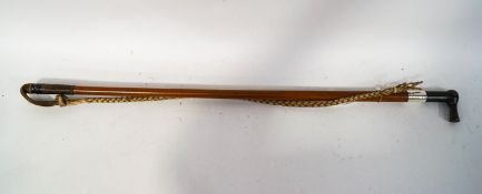 A horseman's malacca shafted whip with white metal band and gate latch opening knop