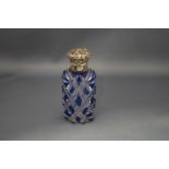A blue flash glass scent bottle, with an unmarked embossed hinged cover,