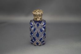 A blue flash glass scent bottle, with an unmarked embossed hinged cover,