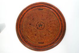 A Burmese lacquer tray, decorated with animals on a stylised ground, 43.