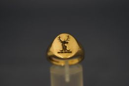 A 9 carat gold signet ring, crested, finger size R1/2, 8.