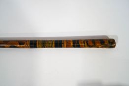 A wooden walking cane with unusual painted decoration