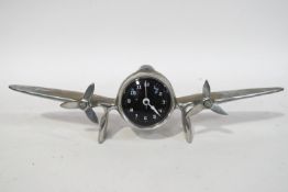 A 1950's aluminium desk clock, modelled as a plane with two propellers,