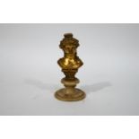 An early 20th century bust on a young lady, gilded on a soapstone socle,