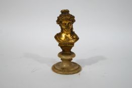 An early 20th century bust on a young lady, gilded on a soapstone socle,