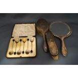 A silver three piece silver dressing table set, comprising a hand mirror,