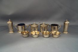 A six piece silver cruet set; with a four Victorian silver salts; a silver mustard spoon;