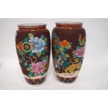A pair of 20th century Chinese baluster vases, decorated with lions, lanterns and peonies,
