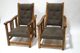 A pair of early-mid 20th century oak and beech reclining armchairs,