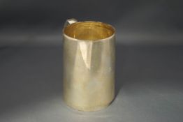 A silver mug, by H.Atkin, Sheffield 1927, of can shape with C shaped handle, 11 cm high, 277 g (8.