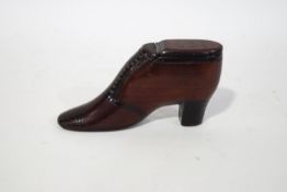 An 18th century Treen snuffbox, in the form of a shoe inset with nail decoration,