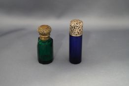 A green glass scent bottle, with an unmarked embossed screw off corked cover, 6.