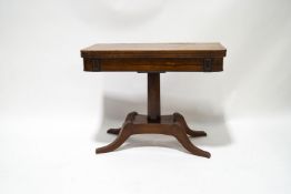 A rosewood card table with William IV crossbanded top on later mahogany base with four splayed legs,