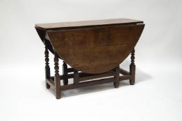 A 19th century oak gateleg table on turned legs,