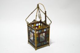 A Victorian brass framed hall lantern with square stained glass panels,