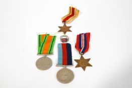 A group of four WWII medals: Defence, 1939-45, Africa Star, 1939-45 Star,
