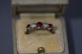 A diamond and ruby five stone ring, the white mount stamped '9ct',