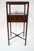 A George III mahogany washstand with single drawer and cross stretcher joining the legs,
