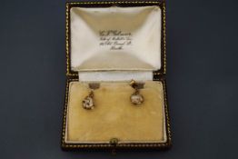 A pair of cage set freshwater baroque pearl drop earrings,