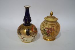A Royal Worcester blush ivory vase and pierced cover, hand painted with flowers and gilt detail, 13.