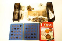 An assortment of coins, including a folder of Great Britian farthings, transport tokens,