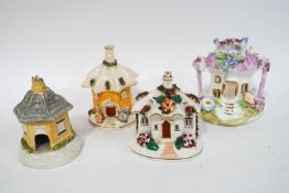 Four 19th century and later Staffordshire pastille burner cottages,