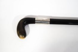 An ebonised walking cane with silver collar and horn handle