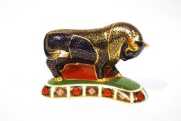 A Royal Crown Derby figure of a bull, with gold stopper and printed marks, 14cm high x 19.