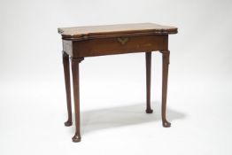 A George III mahogany tea table, the fold over top with shaped corners, on club legs and pad feet,