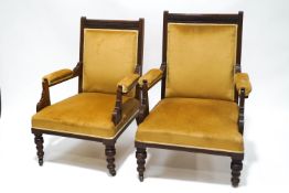A pair of Victorian mahogany Gentleman's and Ladies armchairs, with carved reeded detail,