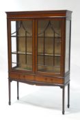 An Edwardian mahogany display cabinet with boxwood stringing, upon square tapering legs,