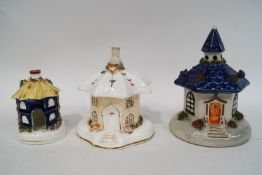 Two 19th century Staffordshire pastille burner cottages 10cm and 13cm high,