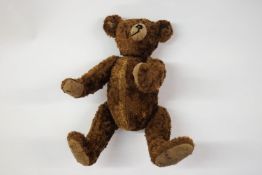 An early 20th century German teddy bear in the style of Steiff,