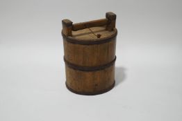 A wine cask with wrought iron bands and strap handle,