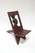 An African hardwood chair, the back carved with a woman's head,