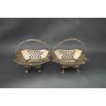 A pair of silver pierced bon bon baskets with swing handles, by H.