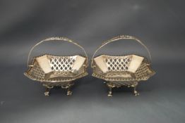 A pair of silver pierced bon bon baskets with swing handles, by H.