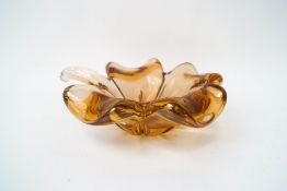 A Studio glass flower head dish, of pale amber colour,