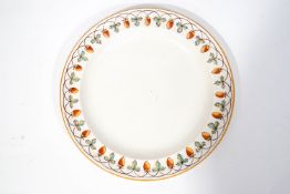 A Wedgwood earthenware plate decorated by Lizzie Morris with a border of strawberries,