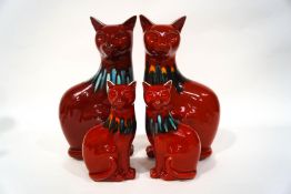 A pair of Poole Pottery 'Living Glaze' seated cats, 29cm high, and a similar smaller pair,