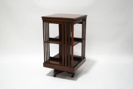 A late Victorian mahogany revolving bookcase on casters,