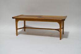 A mid-20th century pine coffee table with stretchered undertier,