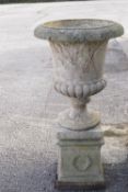 A reconstituted Classical garden urn of Capagna form, on square pedestal base, 109cm high overall,