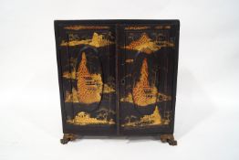 A late 19th century/early 20th century Chinese lacquered table cabinet,