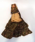 A 19th century German bisque headed doll, with cloth body and papier mache(?) arms,