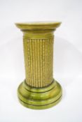 A Victorian green glazed majolica pedestal, with central hole for walking sticks(?),